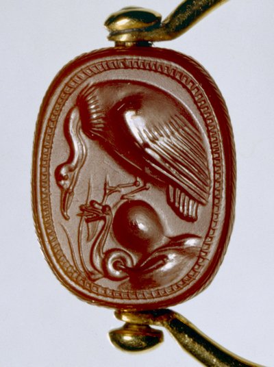 Etruscan gold ring with carnelian scarab as bezel depicting a vulture threatening a coiled snake by Etruscan